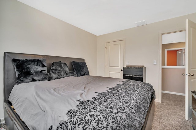 bedroom with carpet, visible vents, and baseboards