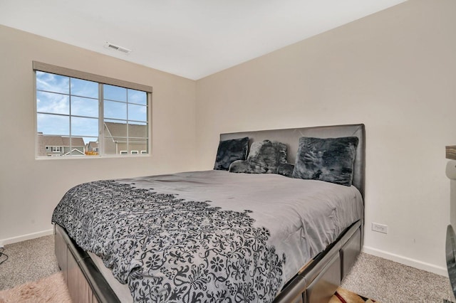 bedroom featuring carpet floors, visible vents, and baseboards