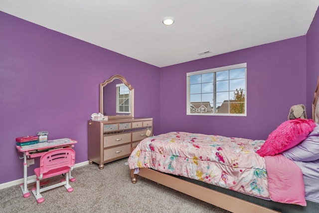 carpeted bedroom featuring baseboards and visible vents