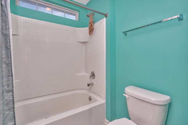 bathroom featuring shower / bath combination with curtain and toilet