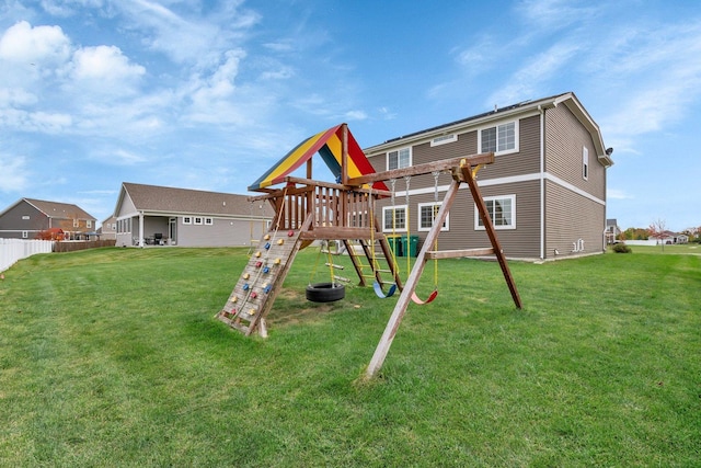 view of play area with a lawn and fence