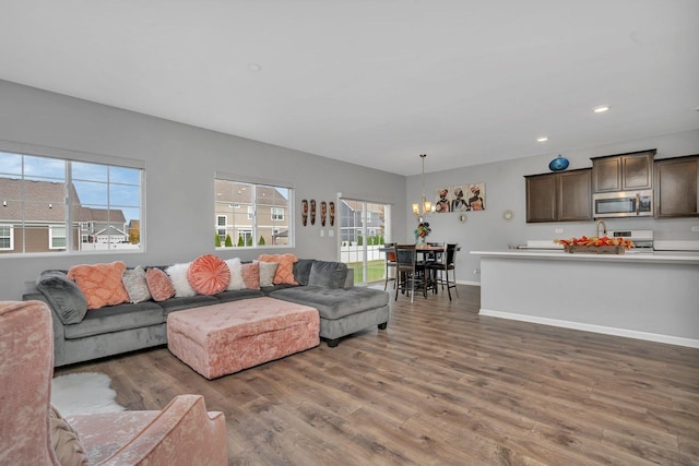 living room featuring recessed lighting, baseboards, and wood finished floors