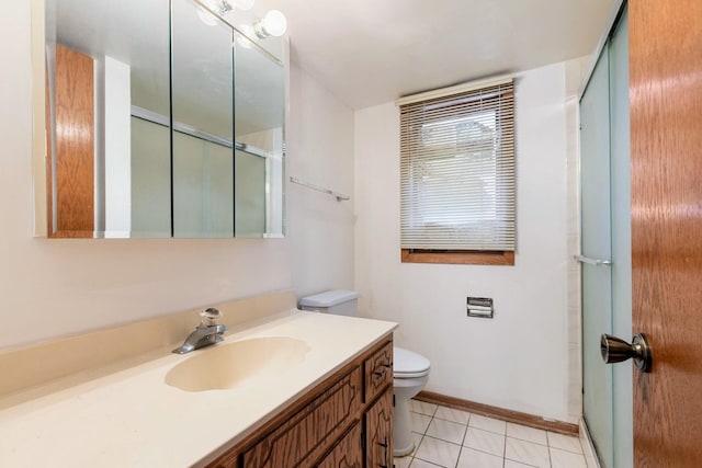 full bath featuring toilet, an enclosed shower, vanity, tile patterned flooring, and baseboards