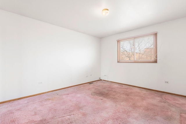 carpeted spare room with baseboards