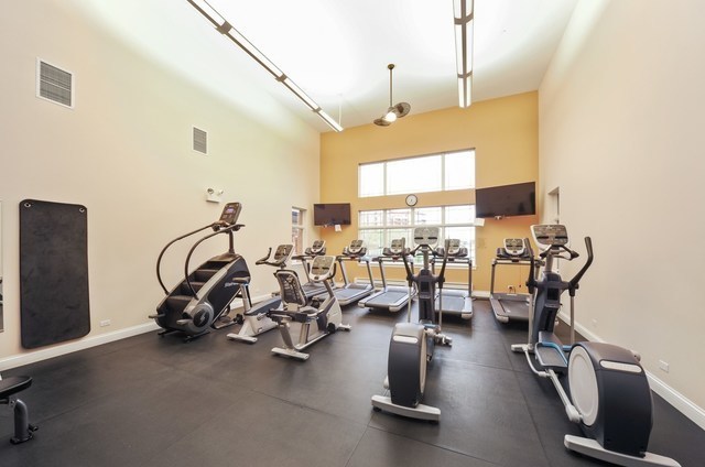 gym featuring baseboards and visible vents