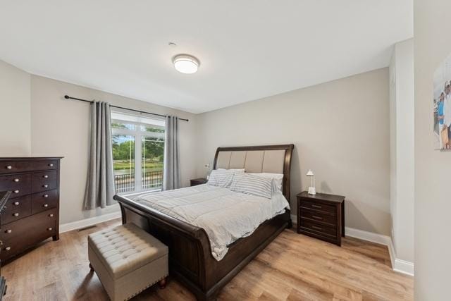 bedroom with baseboards and wood finished floors