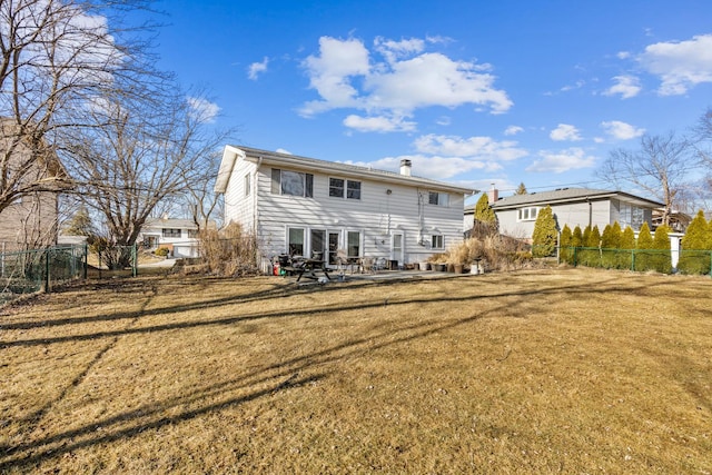 back of property featuring a yard, a patio, and fence