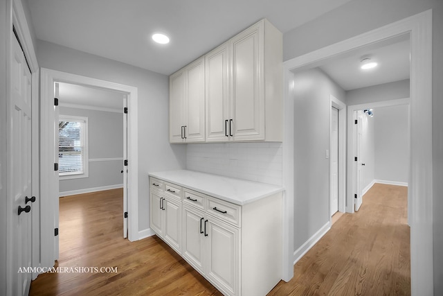 hall with light wood finished floors and baseboards