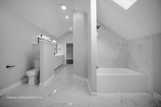 full bathroom with toilet, vanity, baseboards, a bath, and lofted ceiling with skylight