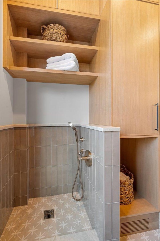 bathroom with tiled shower