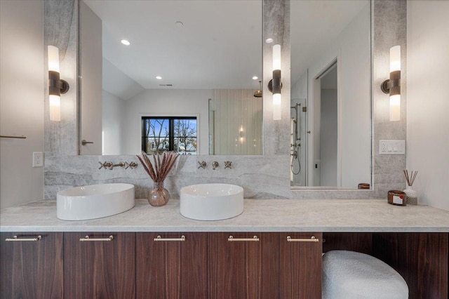 bathroom featuring recessed lighting, a sink, and double vanity