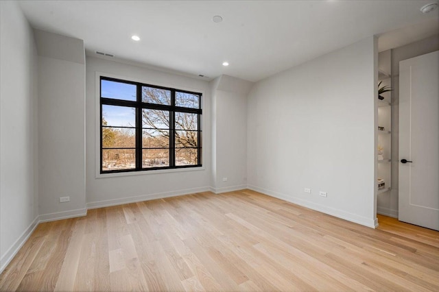 empty room with recessed lighting, light wood-style flooring, and baseboards