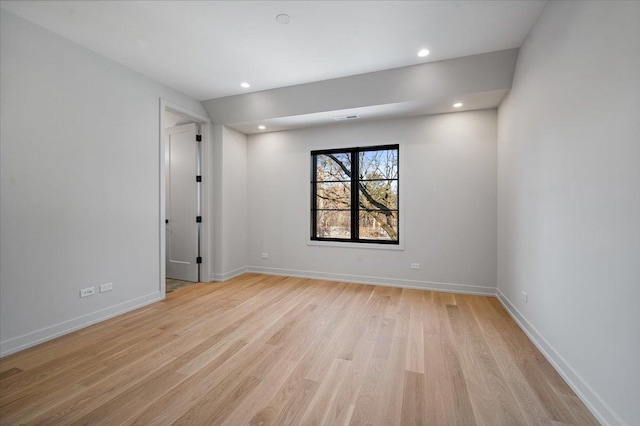 unfurnished room with recessed lighting, light wood-style flooring, and baseboards