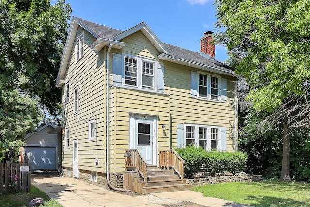 831 W Galena Blvd, Aurora, IL 60506 - view of front facade featuring a chimney, a shingled roof, an outbuilding, a detached garage, and a front lawn