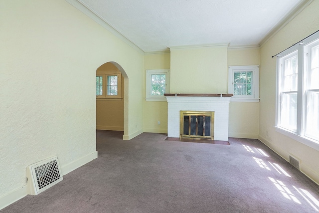 831 W Galena Blvd, Aurora, IL 60506 - unfurnished living room featuring arched walkways, crown molding, a brick fireplace, and carpet
