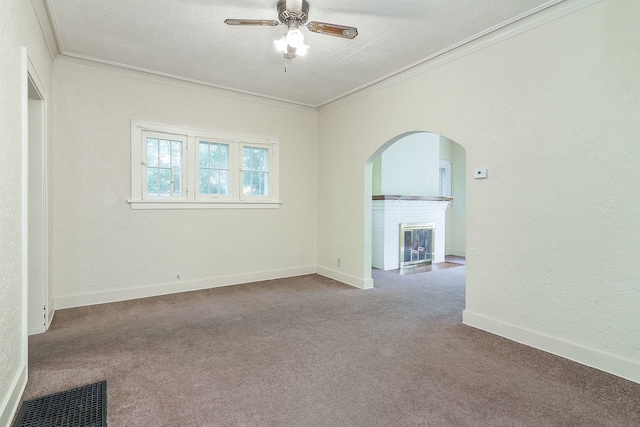 831 W Galena Blvd, Aurora, IL 60506 - unfurnished room with carpet, arched walkways, crown molding, a fireplace with flush hearth, and a ceiling fan