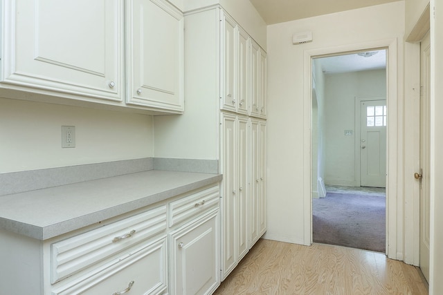 831 W Galena Blvd, Aurora, IL 60506 - kitchen with light wood-style floors, light countertops, and white cabinets