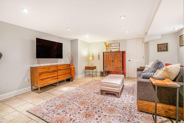 living area featuring recessed lighting and baseboards