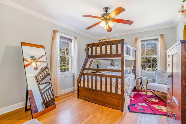 bedroom with multiple windows, wood finished floors, and ornamental molding