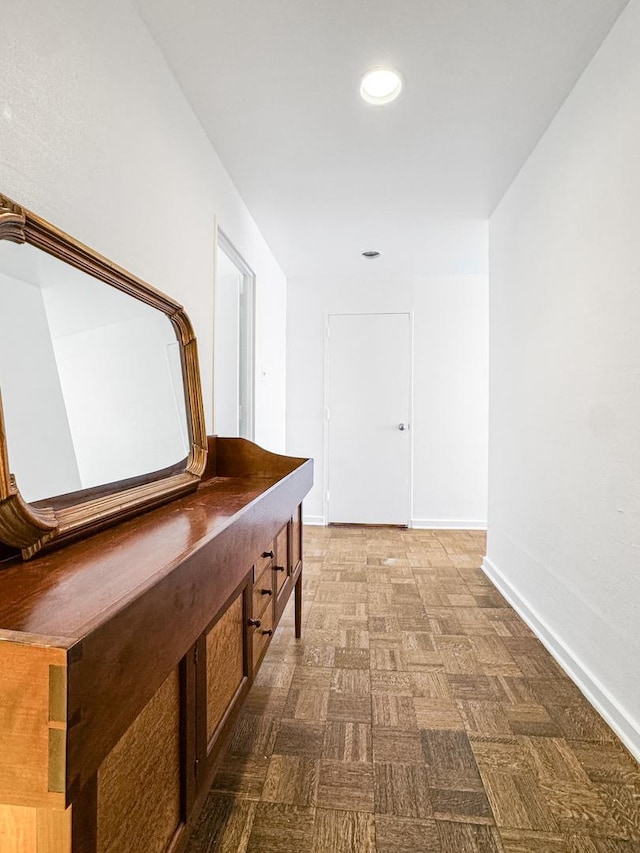 hallway featuring recessed lighting and baseboards