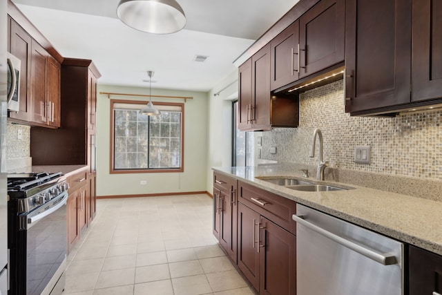 kitchen with tasteful backsplash, visible vents, light stone counters, stainless steel appliances, and a sink