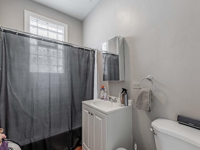 full bathroom with vanity, toilet, and shower / bath combo with shower curtain