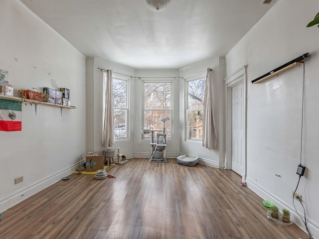 interior space with wood finished floors and baseboards