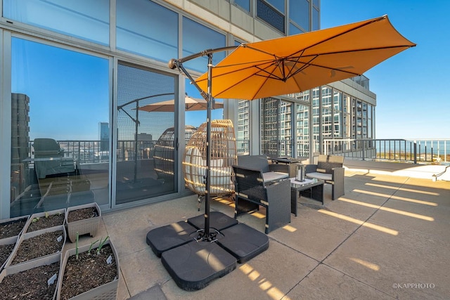view of patio / terrace featuring a garden and a balcony