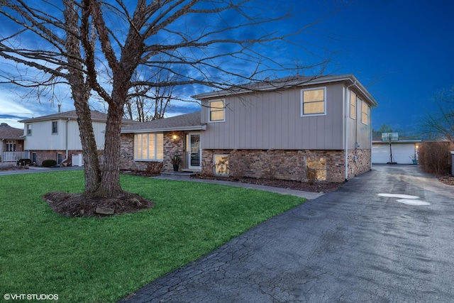 tri-level home with a front lawn