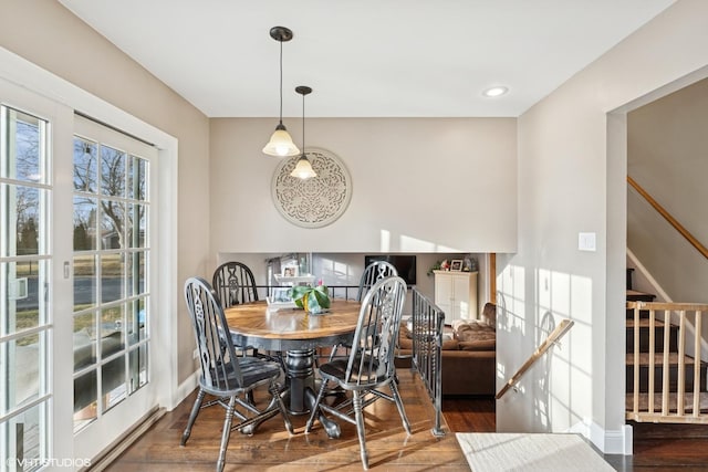 dining area featuring stairs, wood finished floors, and baseboards