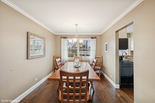 dining space with an inviting chandelier, crown molding, baseboards, and wood finished floors