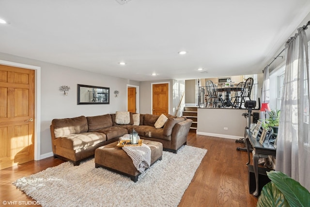 living room featuring dark wood-style floors, baseboards, stairway, and recessed lighting