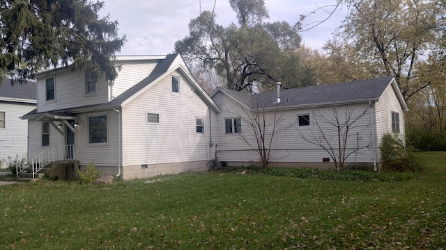 rear view of house with a yard and crawl space