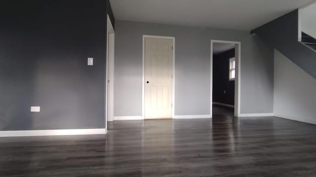 unfurnished room with baseboards and wood finished floors