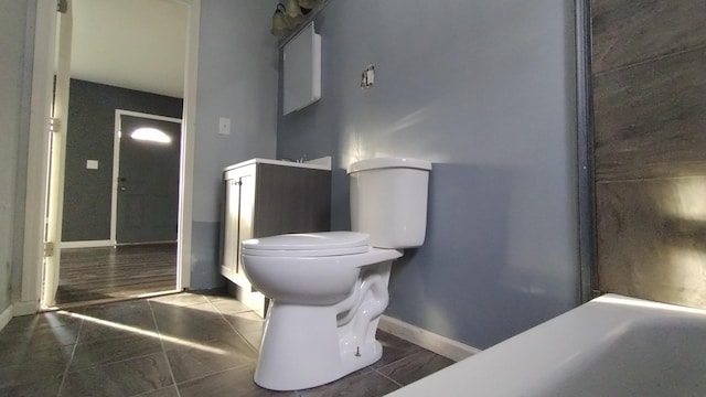 full bath featuring toilet, tile patterned flooring, and baseboards