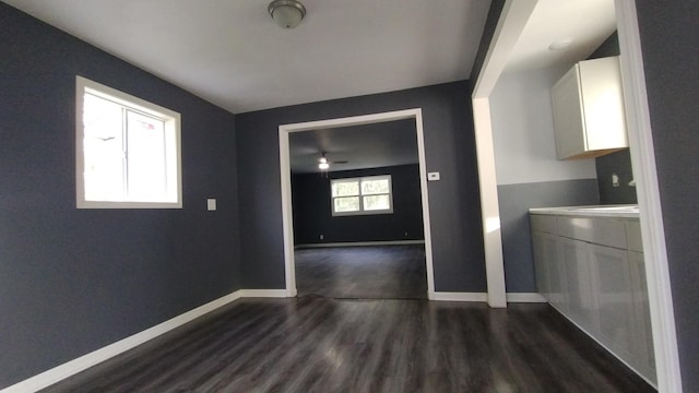 laundry room with dark wood-style floors and baseboards