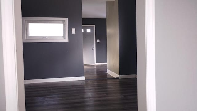 interior space with baseboards and wood finished floors