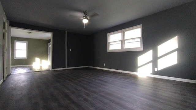 unfurnished room with baseboards and wood finished floors