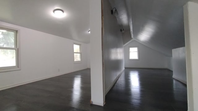 bonus room featuring lofted ceiling, wood finished floors, and baseboards