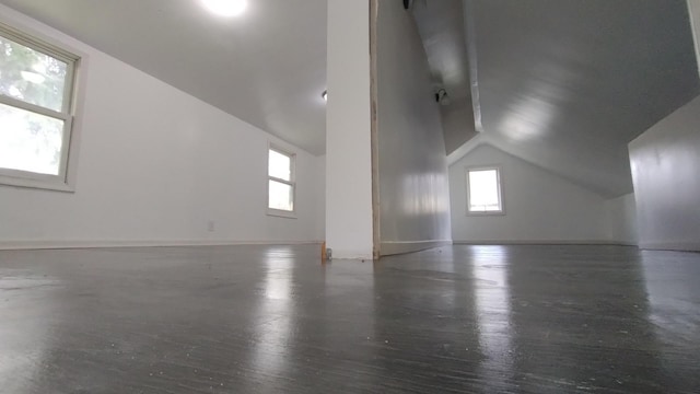 additional living space with lofted ceiling, wood finished floors, and baseboards