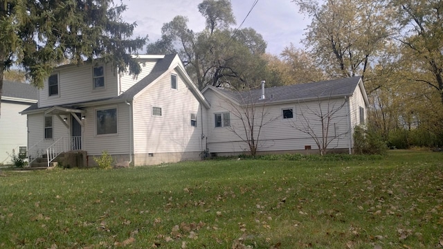 back of property featuring a yard