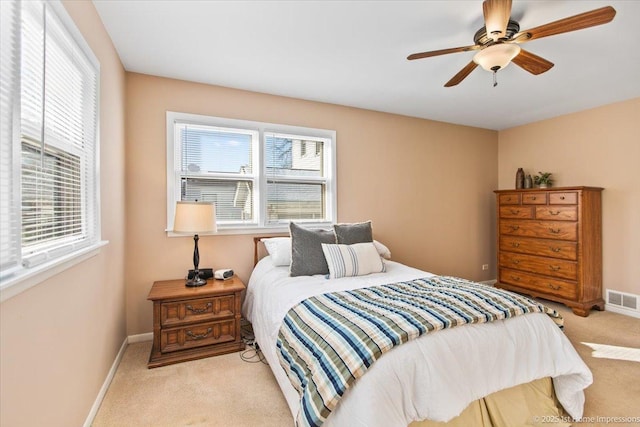 bedroom with carpet, visible vents, ceiling fan, and baseboards