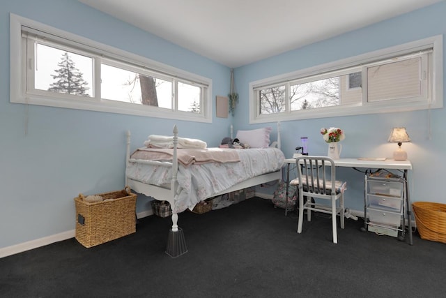 carpeted bedroom featuring baseboards