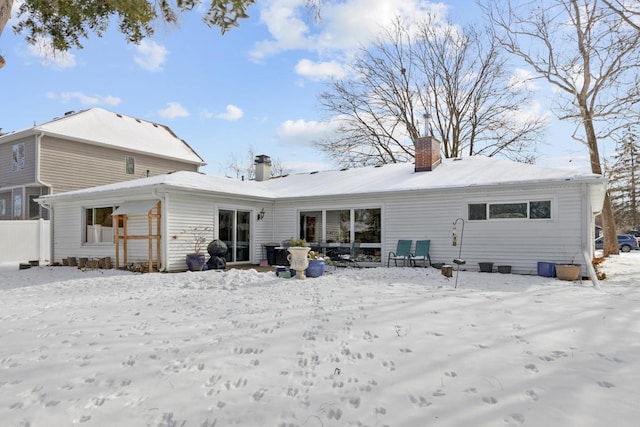 snow covered house with a chimney