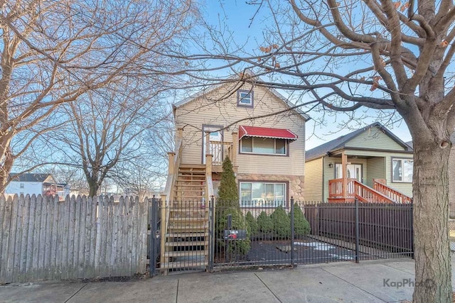 view of front facade with a fenced front yard and a gate