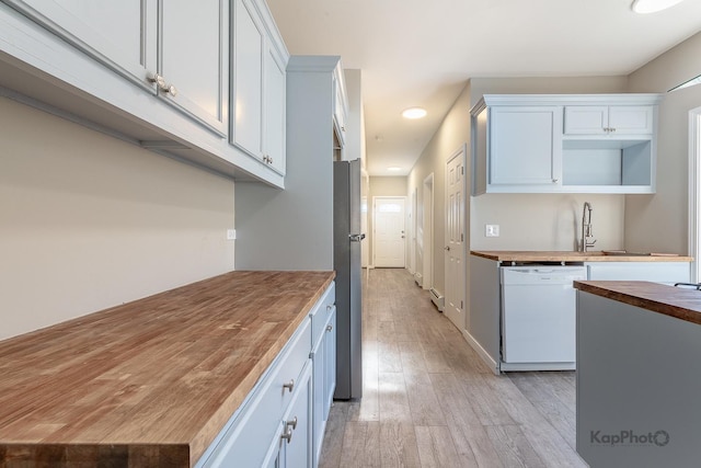 kitchen with open shelves, light wood-style flooring, freestanding refrigerator, wood counters, and dishwasher