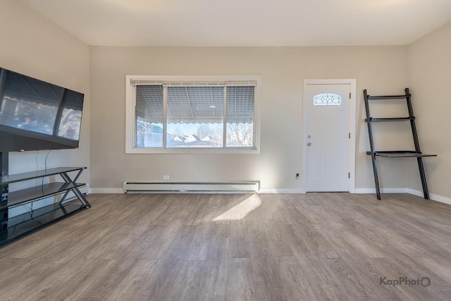 entryway featuring baseboards, baseboard heating, and wood finished floors