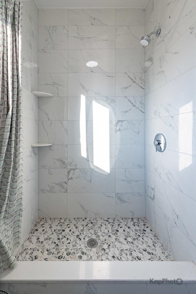 full bath featuring a shower stall