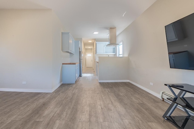 unfurnished living room with light wood-style flooring and baseboards