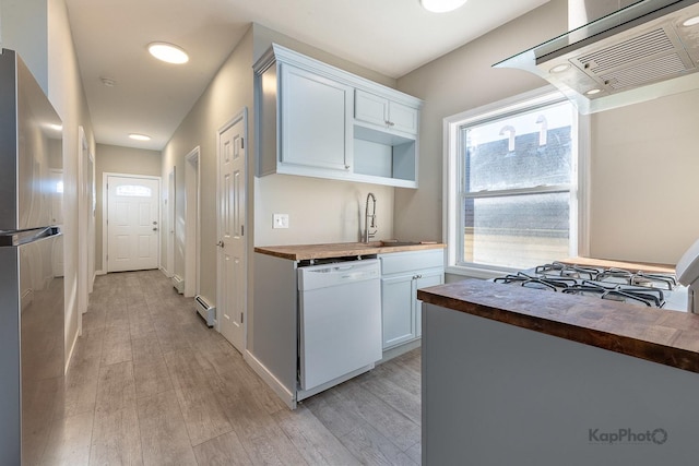 kitchen featuring dishwasher, light wood-type flooring, butcher block countertops, and ventilation hood